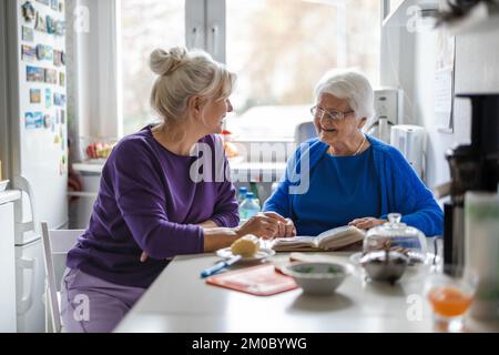 Woman spending time with her elderly mother at home Stock Photo