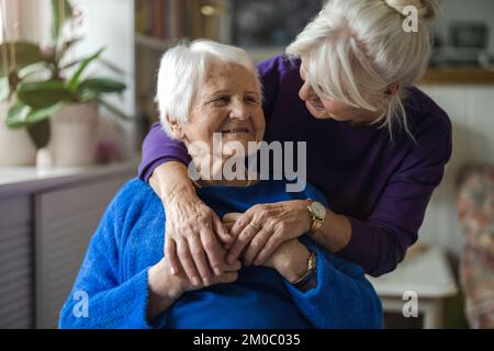 Woman spending time with her elderly mother at home Stock Photo