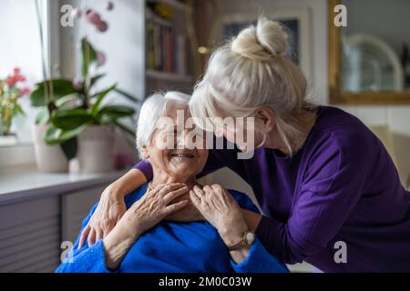 Woman spending time with her elderly mother at home Stock Photo