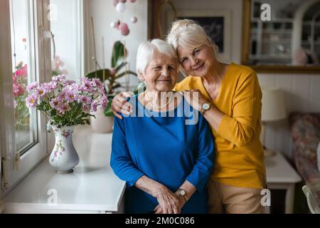 Woman spending time with her elderly mother at home Stock Photo