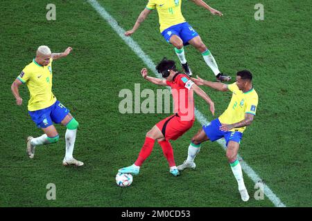 South Korea's Son Heung-min (centre) battles for the ball with Brazil's Richarlison (left), Marquinhos and Danilo (right) during the FIFA World Cup Round of Sixteen match at Stadium 974 in Doha, Qatar. Picture date: Monday December 5, 2022. Stock Photo