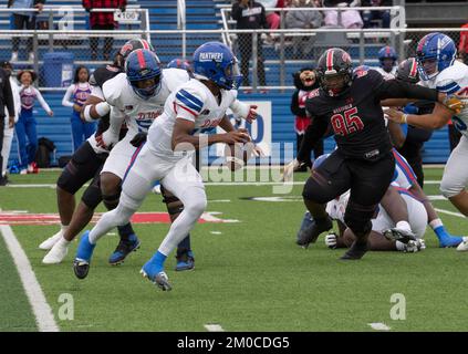 Georgetown Texas USA, December 3 2022: Quarterback scrambles before passing during a University Scholastic League (UIL) quarter-final playoff football game in central Texas. ©Bob Daemmrich Stock Photo