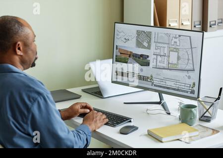 Close up of architect using computer with 3D blueprints on screen, copy space Stock Photo