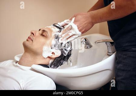 Barber washing hair of caucasian man , close-up Stock Photo
