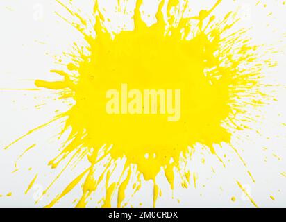 Image of yellow paint spots spilled on background of white paper Stock Photo