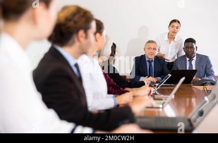 Executive team holding corporate meeting at office with assistance secretary's support Stock Photo