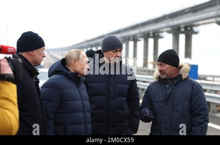 Kerch Straits, Russia. 05th Dec, 2022. Russian President Vladimir Putin, 2nd left, listens to Deputy General Director of Nizhneangarsktransstroy Yevgeny Chibyshev, right, during a visit to the Kerch Strait Bridge, that links Russian mainland with the Crimean Peninsula, December 5, 2022 in Kerch, Russia. Standing left to right are: Deputy Prime Minister Marat Khusnullin, President Vladimir Putin, Federal Road Agency Chief Engineer Nikita Khrapov, and Deputy General Director of Nizhneangarsktransstroy Yevgeny Chibyshev. Credit: Mikhail Metzel/Kremlin Pool/Alamy Live News Stock Photo