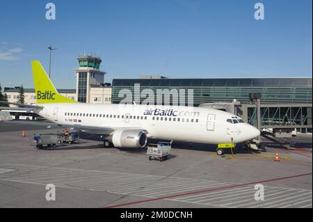 RIGA, LATVIA - JUNE 13, 2011: airBaltic Boeing 737 docked in Riga airport. June 13, 2011. AirBaltic operates about 60 direct flights from Riga. Stock Photo