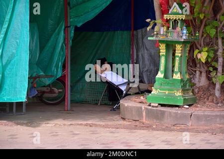 A Lao man relaxing before setting up for the night market in Vientiane, Laos, Southeast Asia. Stock Photo