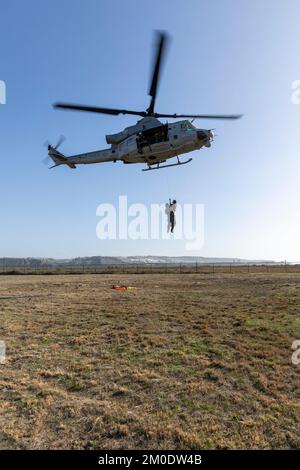 U.S. Marines with Marine Light Attack Helicopter Squadron 169, Marine Aircraft Group 39, 3rd Marine Aircraft Wing (MAW), lift Cpl. Jacob Dinwiddie, a UH-1Y Venom weapons and tactics instructor, and U.S. Navy Master Chief Petty Officer Ryan Grant, a departmental leading chief petty officer with Helicopter Sea Squadron 3, during Steel Knight 23, on Imperial Beach, California, Nov. 29, 2022. The exercise provides 3rd MAW an opportunity to refine Wing-level warfighting in support of I Marine Expeditionary Force and fleet maneuver. Dinwiddie is a native of Indianapolis. (U.S. Marine Corps photo by Stock Photo