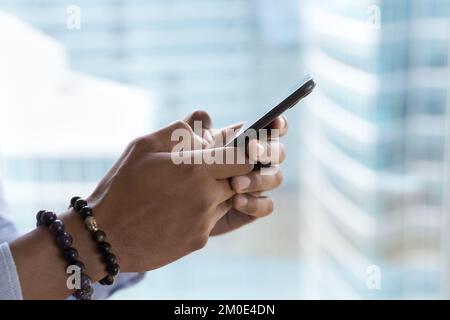 Mobile phone in male hands close up side view shot Stock Photo