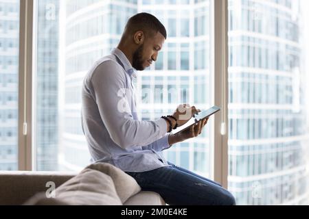Focused positive young entrepreneur man working on project at home Stock Photo
