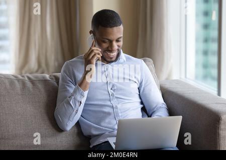 Happy millennial Black freelancer man, entrepreneur negotiating on business project Stock Photo