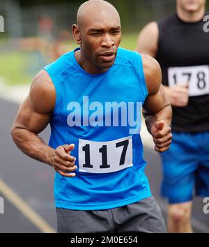 Getting a head start. Cropped front view of a male runner at the start of the race with his competitor number displayed on his sport shirt. Stock Photo