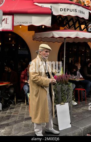 An old man in trench coat is ready to cross the road. Stock Photo