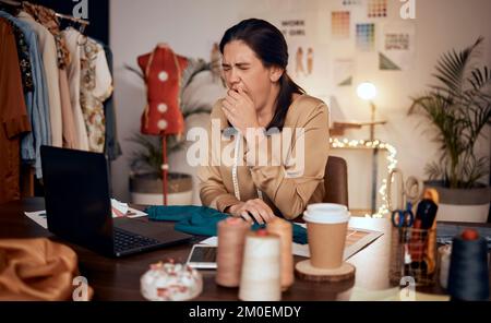 Fashion, laptop and design woman tired after overtime on creative work, startup small business or luxury clothes. Fatigue, yawn and designer girl with Stock Photo