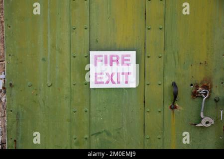 old faded fire exit sign Stock Photo