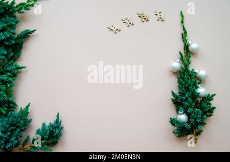 Christmas flat lay composition of craft gift boxes with fir branches on the beige background. Hand made paper boxes with Christmas tree branch. Copy s Stock Photo