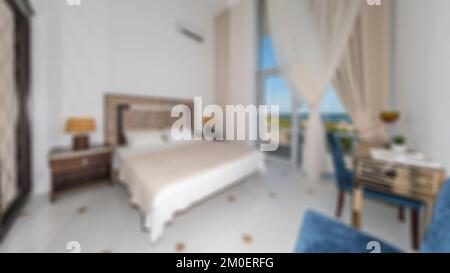 Defocused and blurred photo of luxury and modern bedroom with sea view in hotel apartment interior design. Ideal for background. Stock Photo