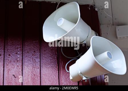 two white speakers on a school wall Stock Photo