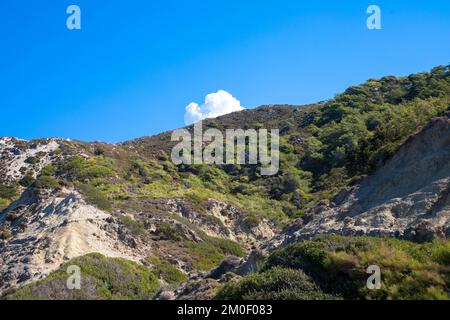 Panoramic view of typical greek mediterranean landscape with hill, olive trees and bushes. Tourism and vacations concept. Rhodos Island, Greece. Stock Photo