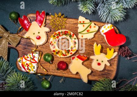 Funny Christmas breakfast, toasts cheese sandwiches in the form of Christmas trees, reindeer,  snowmen. christmas wreath, sock. With Christmas tree br Stock Photo