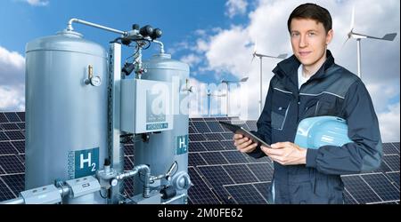 Engineer with tablet computer on a background of Green Hydrogen factory Stock Photo