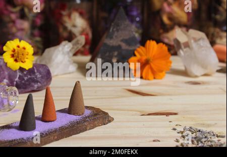Incense Cones on Stone Slab With Rock Crystals and Flowers Stock Photo