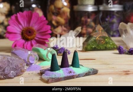 Incense Cones on Stone Slab With Chakra Crystals and Flowers Stock Photo