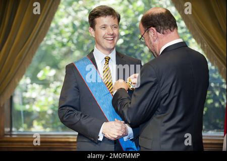 Danish Crown Prince Frederick is being decorated with the Chancellery of Chile's medal of merit by Chilean Foreign Affairs minister Alfredo Moreno, at La Moneda Palace in Santiago, Chile, 11 March 2013. Stock Photo