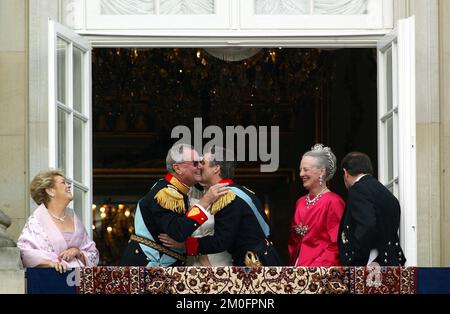 The Crown Princess Mary (hidden) and Prince Frederik of Denmark (centre) on the balcony at Amalienborg Palace being cheered by the Danes, with Mrs. Susan Moody (left), The Danish Prince Consort Henrik (2nd left), The Queen Margeret (red dress) and Mr. John Donaldson (right). Stock Photo