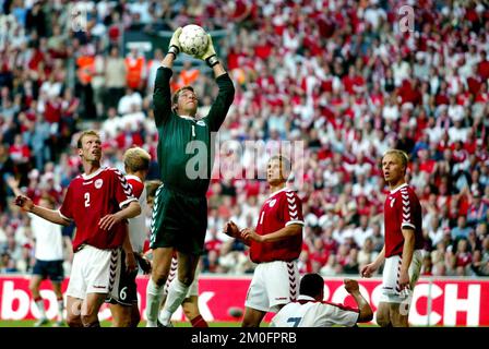 Denmark's goalkeeper Thomas Sorensen catches the ball under the watchful eyes of  Morten Wieghorst of Brondby (left), Ebbe Sand of Schalke 04 and Martin Laursen (right) of Milan, during their Euro 2004 qualification match against Norwway. Stock Photo