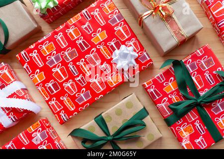Top view of different gift boxes wrapped with ribbons and bows on wooden background. Stock Photo