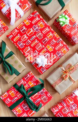 Top view of different gift boxes wrapped with ribbons and bows on wooden background. Stock Photo