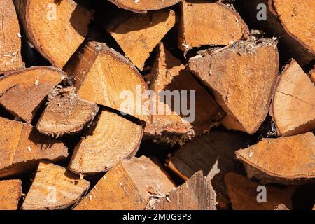 Stock of firewood, cutted birch wood chocks are stacked in rural barn Stock Photo