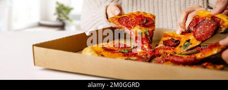 hands taking pizza slices from box. party snacks. banner with copy space Stock Photo