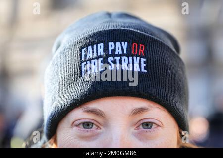 London, UK. 06th Dec, 2022. A female firefighter with 'Fair Pay or Fire Strike' hat. Firefighters, control staff and members of the Fire Brigades Union (FBU) rally in Westminster and lobby MPs today to mark the start of a ballot for strikes. FBU members have rejected the current pay offer and are voting on whether strikes will go ahead. Credit: Imageplotter/Alamy Live News Stock Photo