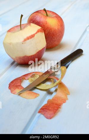 Peeled apple with peeling knife, apple peels Stock Photo