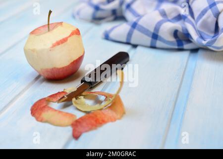 Peeled apple with peeling knife, apple peels Stock Photo