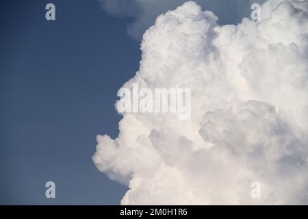 Large cumulonimbus cloud against blue sky in the summertime Stock Photo