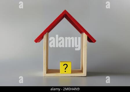 House with a question mark. Cost estimate. Solving housing problems, buy or rent real estate. Property price valuation Stock Photo
