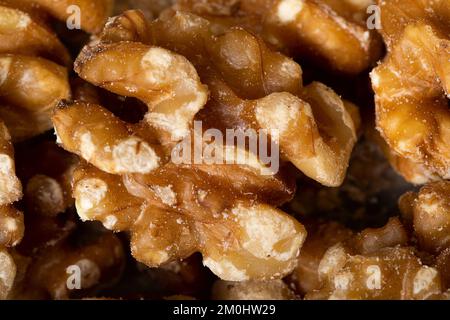 The texture of walnut as a background. Close up shot of nuts. Macro photo. Stock Photo