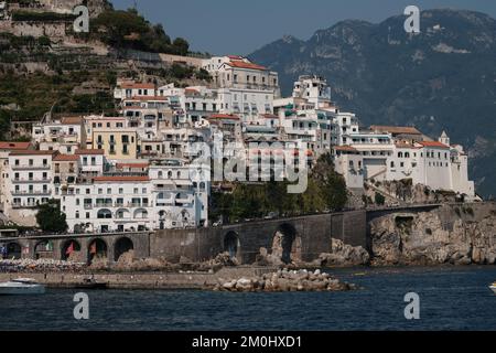 A view of Amalfi town towards the east side with the properties on the rising cliffs with the sea and harbour in the foreground. Stock Photo