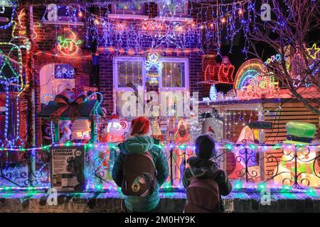 London, UK. 06th Dec, 2022. Local children (parental permission obtained) look at the 'Honor Oak Christmas House', an annual Christmas lights display at a house in Honor Oak Park, Lewisham, South East London. The display raises funds for charity, this year the chosen charity is Lewisham Food Bank. The display has gone up for many years and delights locals during the festive season. Credit: Imageplotter/Alamy Live News Stock Photo