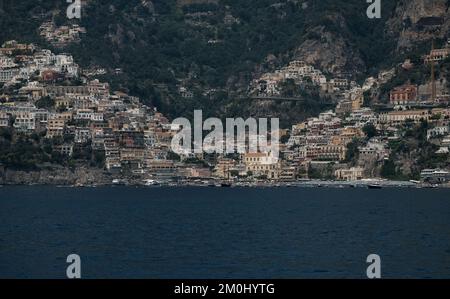 The colourful houses, shops and hotels of Positano layered vertical on the cliffs Italy. Image taken from out to sea looking towards Marina Grande. Stock Photo