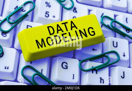 Hand writing sign Data Modeling. Word for process of transferring data between data storage systems Stock Photo