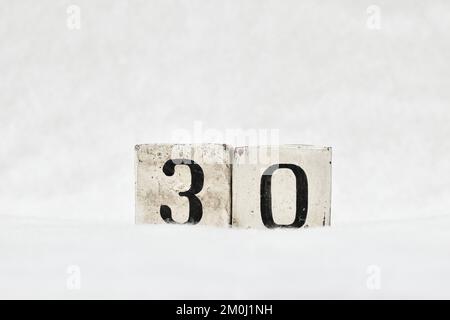 30 vintage wooden block calendar number on white snow background, copy space for text. Save the date for birthday, anniversary, special day or occasio Stock Photo