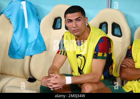 Lusail, Qatar. 06th Dec, 2022. Soccer, 2022 World Cup in Qatar, Portugal - Switzerland, Round of 16, at Lusail Stadium, Portugal's Cristiano Ronaldo sits on the substitutes' bench for the start of the match. Credit: Tom Weller/dpa/Alamy Live News Stock Photo