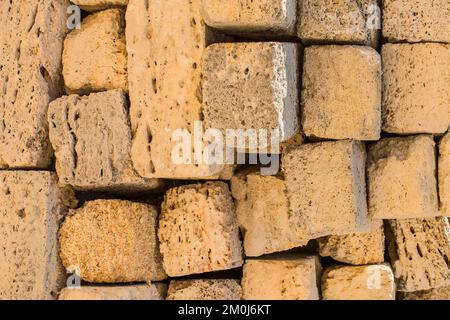 A pile of brick coquina blocks of shell sand stone material close-up limestone background. Stock Photo
