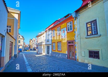 The line of old small houses on Brandlova Street, one of them is decorated with vintage sun dial, Kolin, Czech Republic Stock Photo